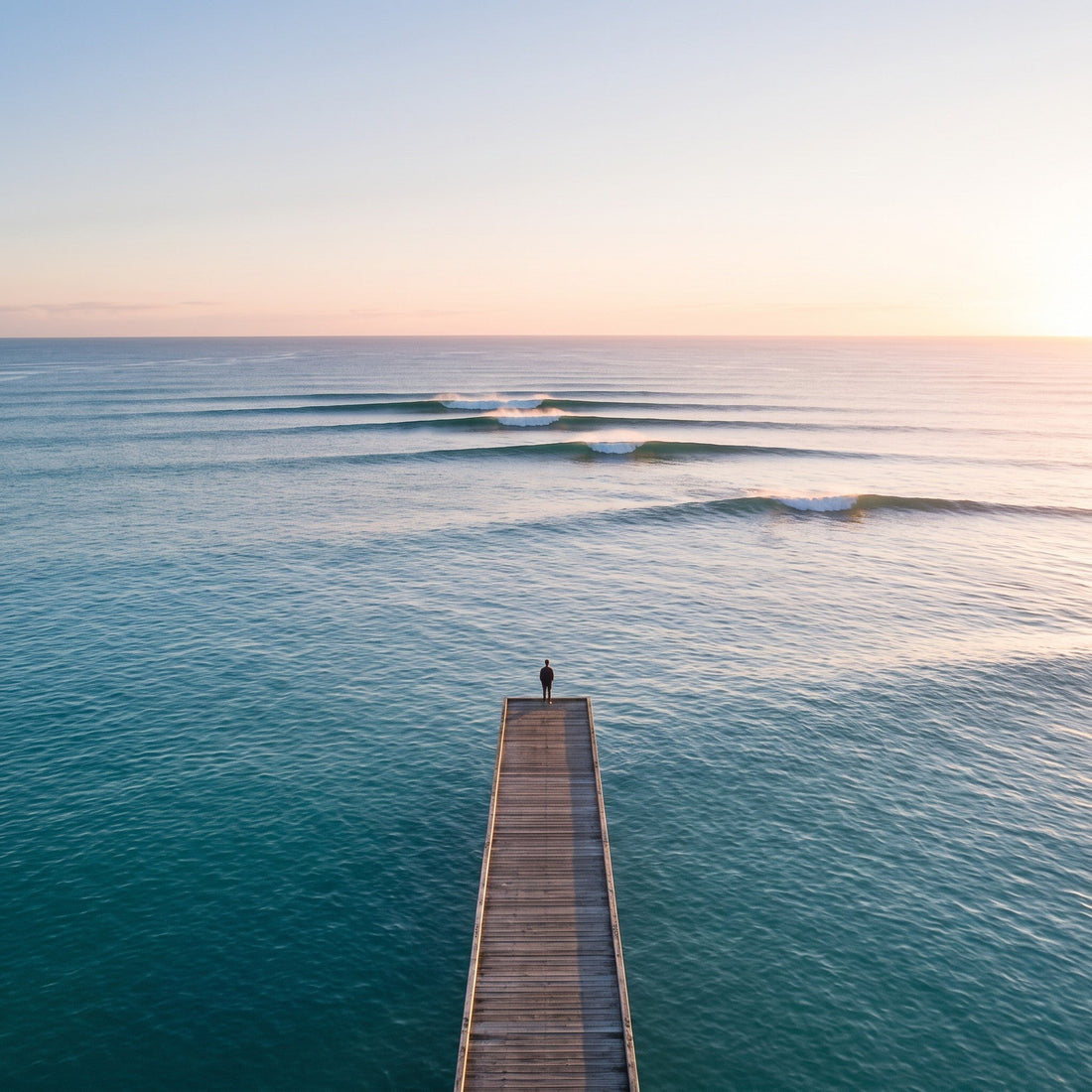 Person quietly looking across the ocean at sunrise while reflecting on faith, life and God's creation.