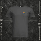 Dark Grey Deepwater Crew Co. Be Salty, Stay Lit crewneck T-shirt, front view with small cross, sunset, and blue-wave crest.
