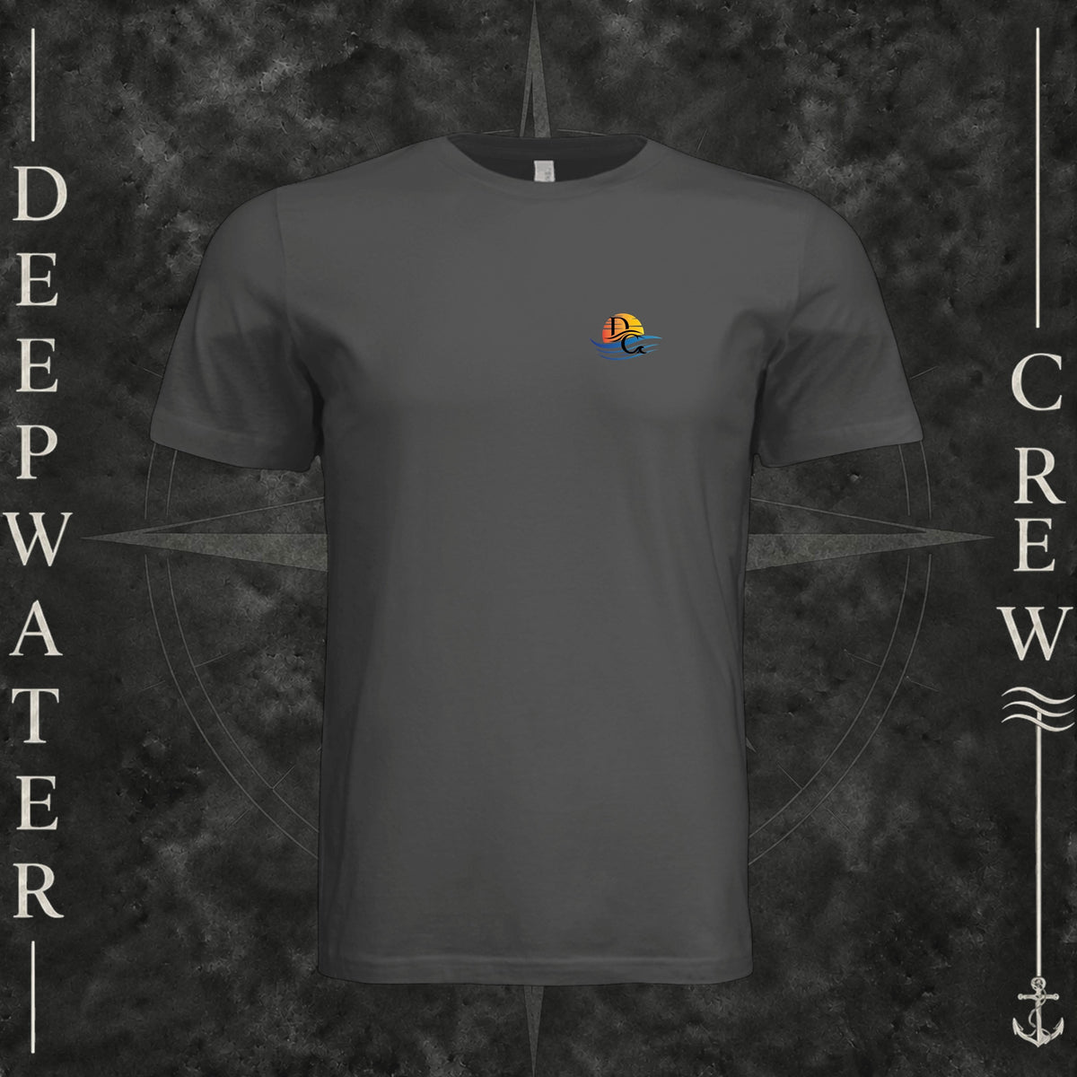 Dark Grey Deepwater Crew Co. Be Salty, Stay Lit crewneck T-shirt, front view with small cross, sunset, and blue-wave crest.