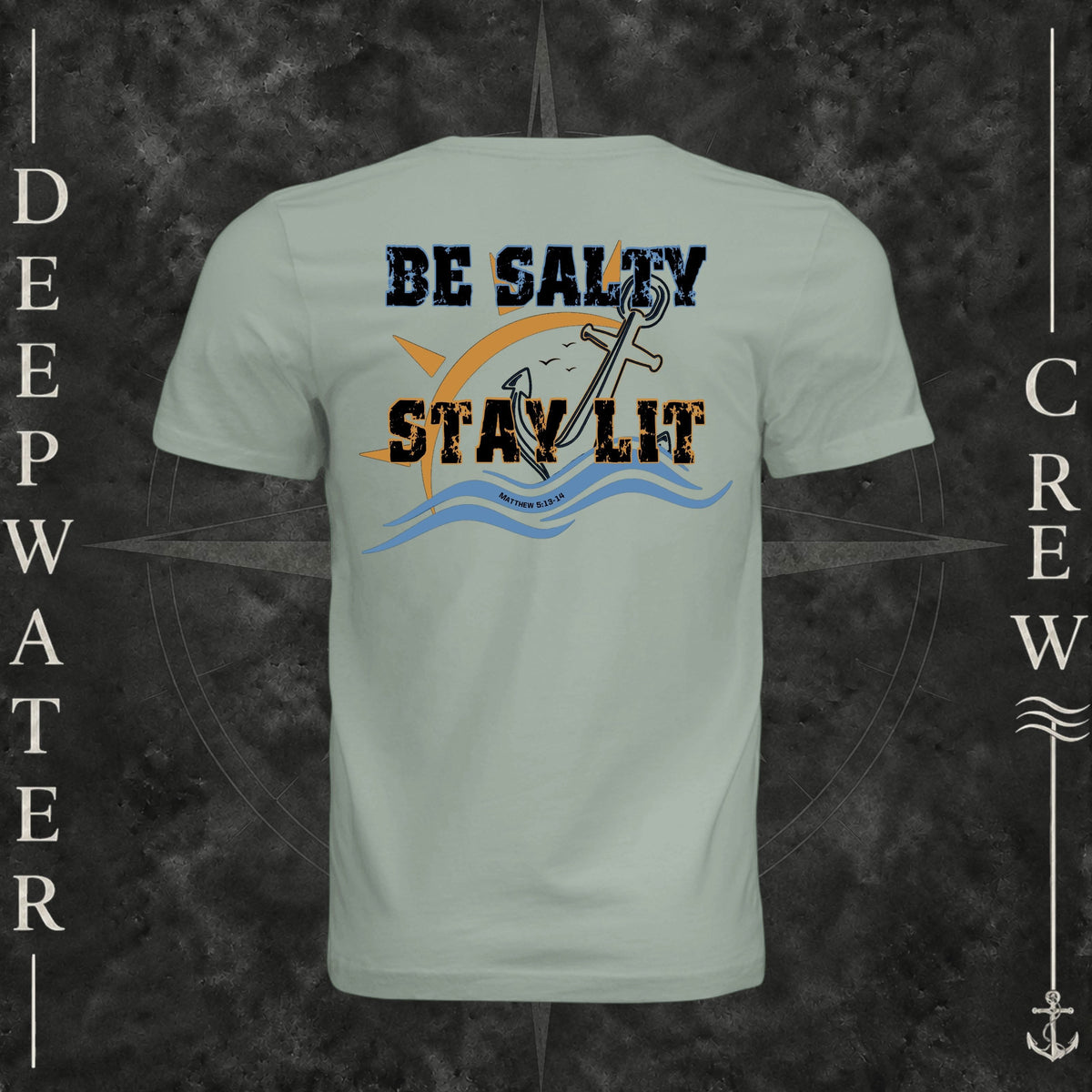 Dusty Blue Deepwater Crew Co. Be Salty, Stay Lit crewneck T-shirt, back view with distressed Be Salty, Stay Lit lettering, anchor, sun, blue waves, and Matthew 5:13–14.
