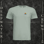 Dusty Blue Deepwater Crew Co. Be Salty, Stay Lit crewneck T-shirt, front view with small cross, sunset, and blue-wave crest.