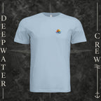 Light Blue Deepwater Crew Co. Be Salty, Stay Lit crewneck T-shirt, front view with small cross, sunset, and blue-wave crest.