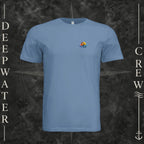 Slate Deepwater Crew Co. Be Salty, Stay Lit crewneck T-shirt, front view with small cross, sunset, and blue-wave crest.