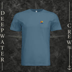Steel Blue Deepwater Crew Co. Be Salty, Stay Lit crewneck T-shirt, front view with small cross, sunset, and blue-wave crest.