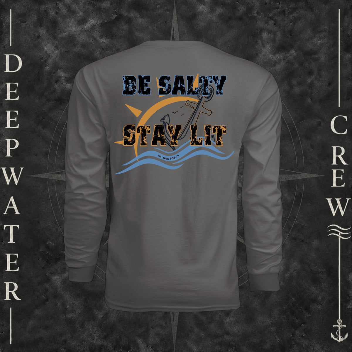 Graphite Deepwater Crew Co. Be Salty, Stay Lit UPF 44+ long-sleeve performance shirt, back view with distressed Be Salty, Stay Lit lettering, anchor, sun, blue waves, subtle cross, and Matthew 5:13–14.