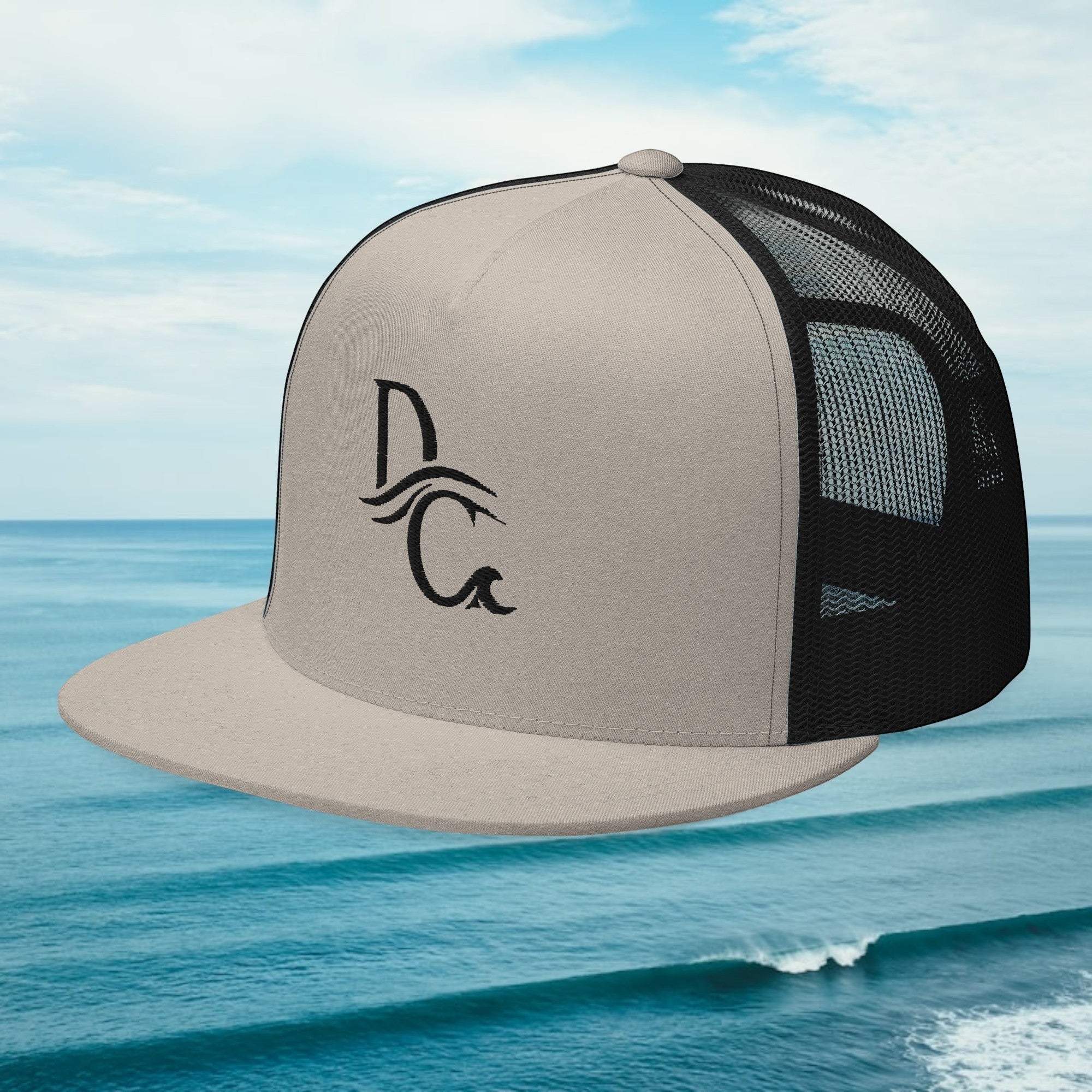 Deepwater Crew Co. beige and black 5-panel trucker cap with flat bill and embroidered wave-and-compass logo