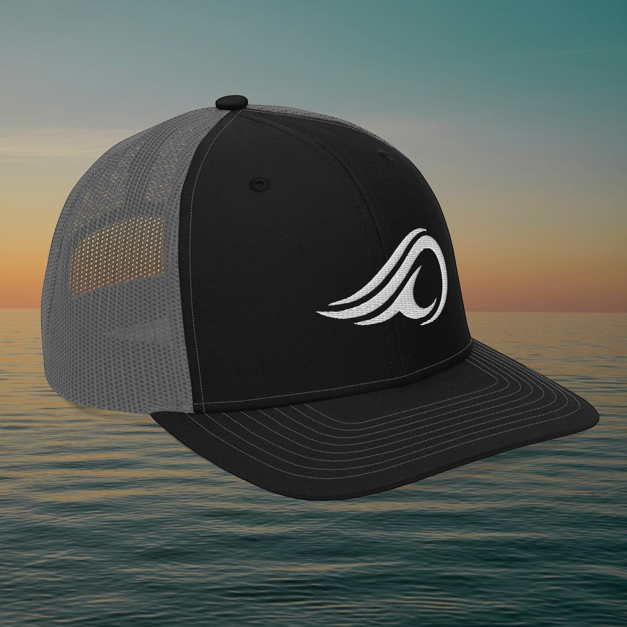 Deepwater Crew Co. black and grey trucker cap with white embroidered wave logo on the front structured panel.