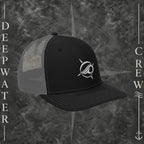 Deepwater Crew Co. Horizon coastal trucker hat in black and grey with an embroidered wave-and-compass logo.