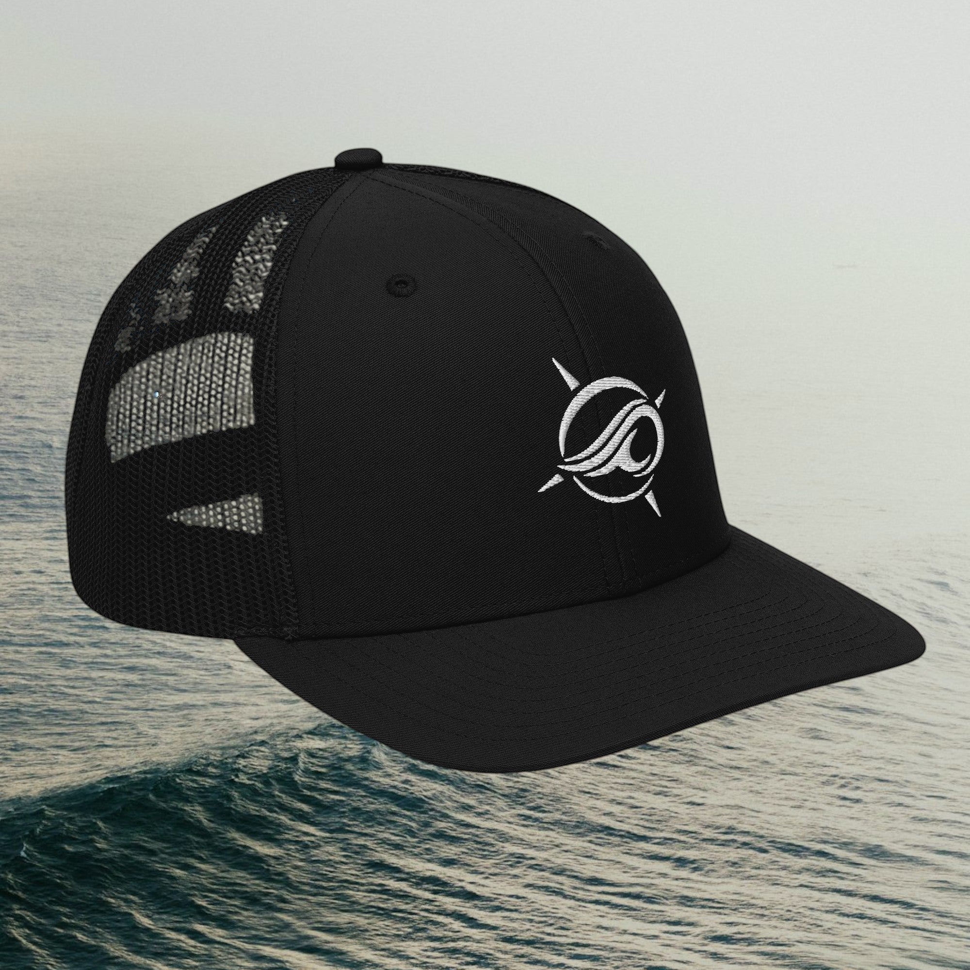 Deepwater Crew Co. black trucker cap with white embroidered wave logo, mesh back, and adjustable snapback closure.