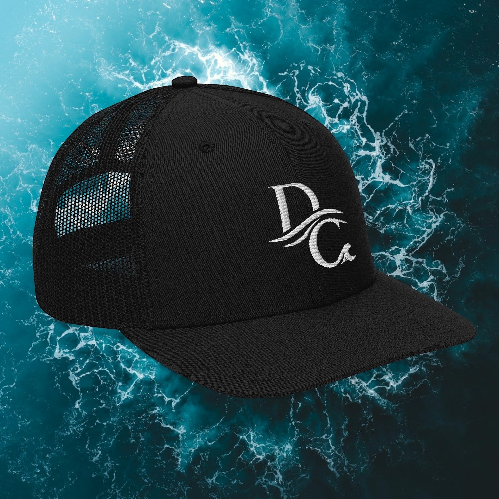 Deepwater Crew Co. black trucker hat with white embroidered wave logo, mesh back, and adjustable snapback closure.