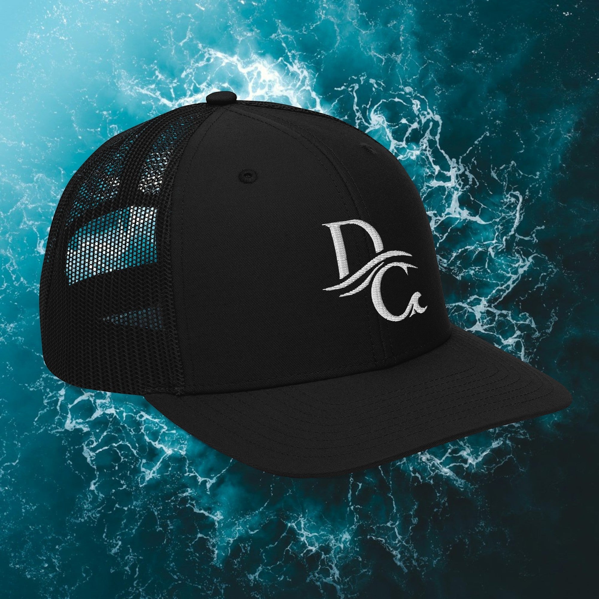 Deepwater Crew Co. black trucker hat with white embroidered wave logo, mesh back, and adjustable snapback closure.