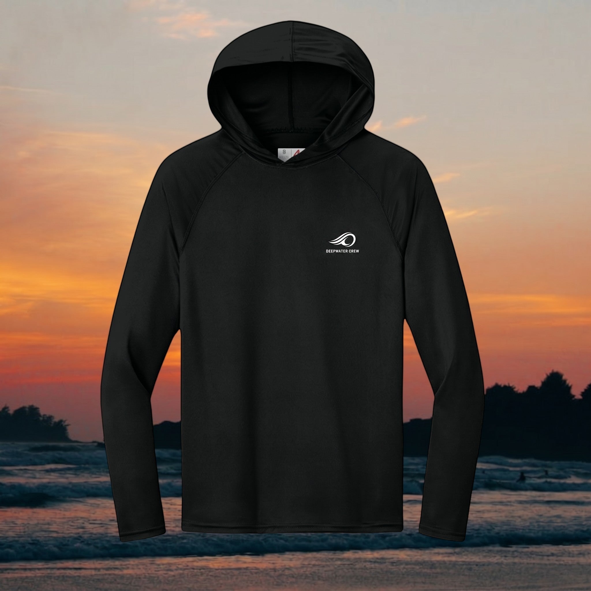 Deepwater Crew Co. black long-sleeve performance UPF hoodie with raglan sleeves and logo on a sunset beach background.