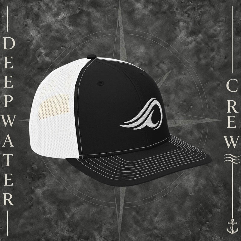 Deepwater Crew Co. black and white Richardson 112 trucker hat with white embroidered wave logo, breathable mesh back, and structured six-panel design with snapback closure.