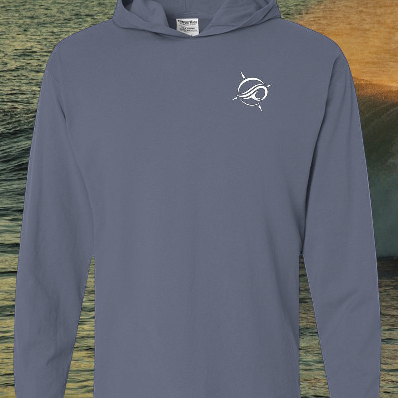 Deepwater Crew Co. blue garment-dyed long sleeve hooded t-shirt with white chest logo on a coastal background