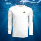 White Deepwater Crew Co. Bluewater Strike UPF 44+ long-sleeve performance shirt, front view with small DC sunset and ocean wave chest logo. Background is under crystal clear blue water with rays of sunlight beaming through.