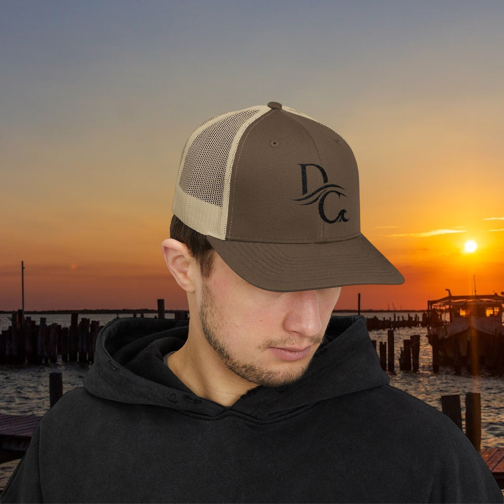 Deepwater Crew Co. brown and tan trucker hat with embroidered DC logo. Structured mid-profile with mesh back.