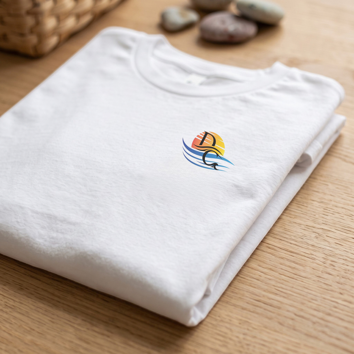 Folded White Deepwater Crew Co. Called to Fish T-shirt showing the small sunset-and-wave crest with DC logo.