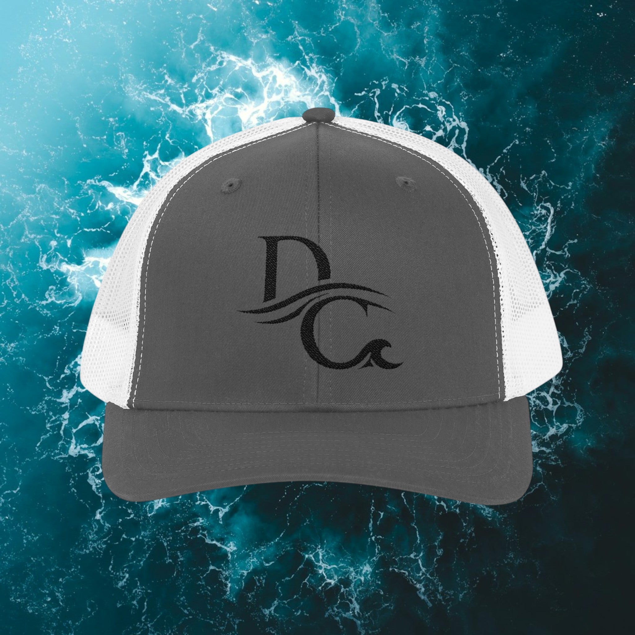 Deepwater Crew Co. charcoal trucker hat with white mesh back and embroidered DC wave logo.