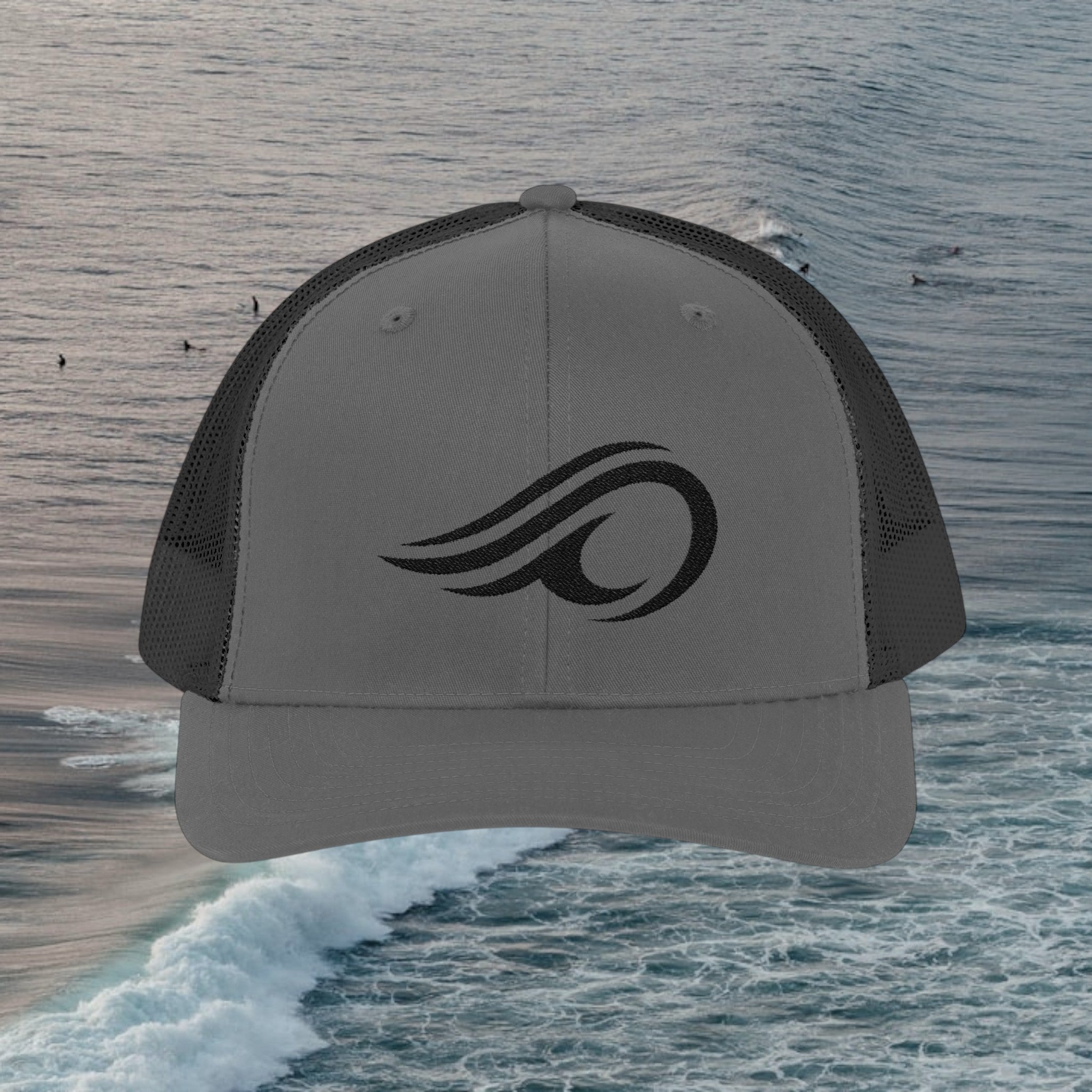 Deepwater Crew Co. charcoal grey trucker hat with black mesh back and embroidered wave logo.