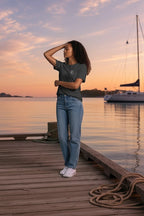 Deepwater Crew Co. dark grey cotton crew neck t-shirt with small white logo on chest, worn by a woman on a dock.