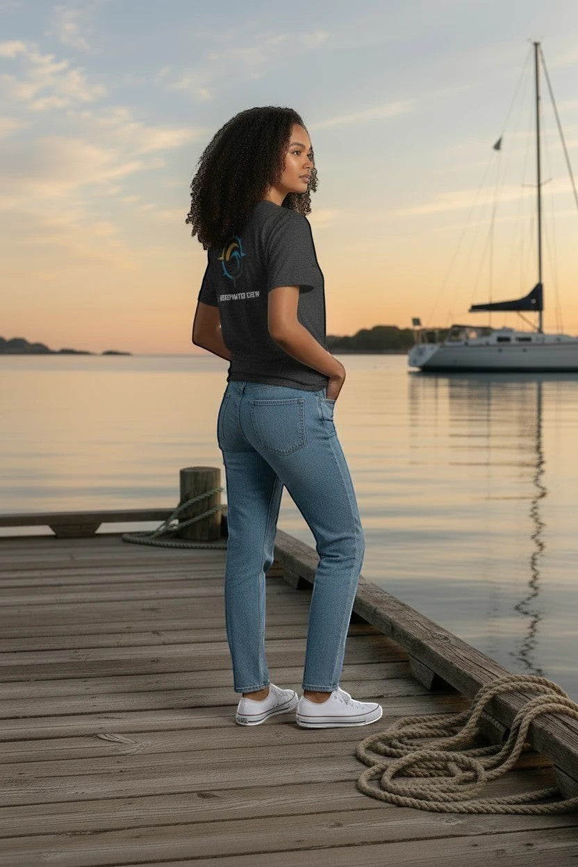 Deepwater Crew Co. dark grey crew neck t-shirt with logo on back, worn by a woman on a dock at sunset.
