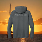 Deepwater Crew Co. dark grey performance UPF hoodie with white logo on back against a sunset ocean background