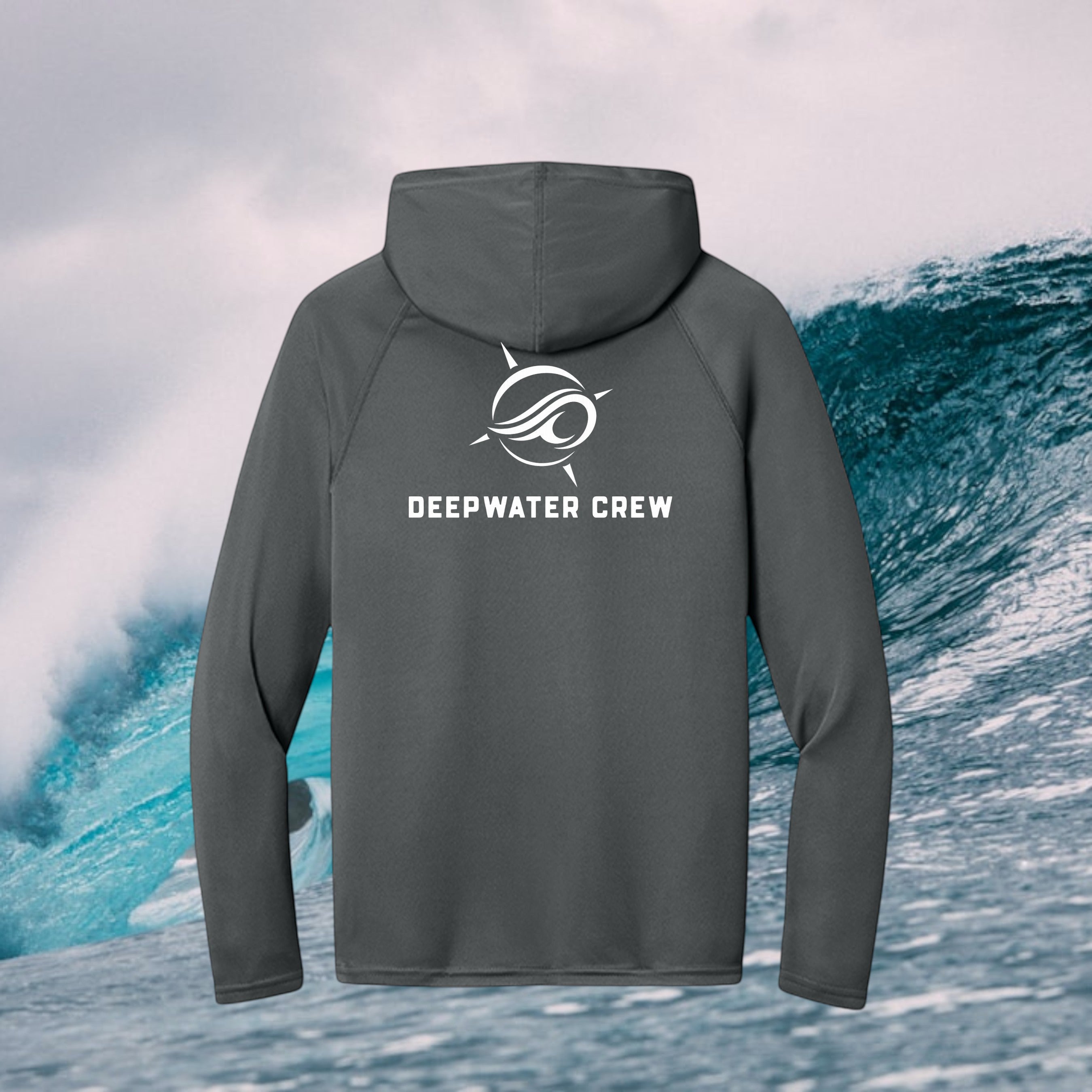 Deepwater Crew Co. dark grey long-sleeve performance UV hoodie with white logo on back against an ocean wave background