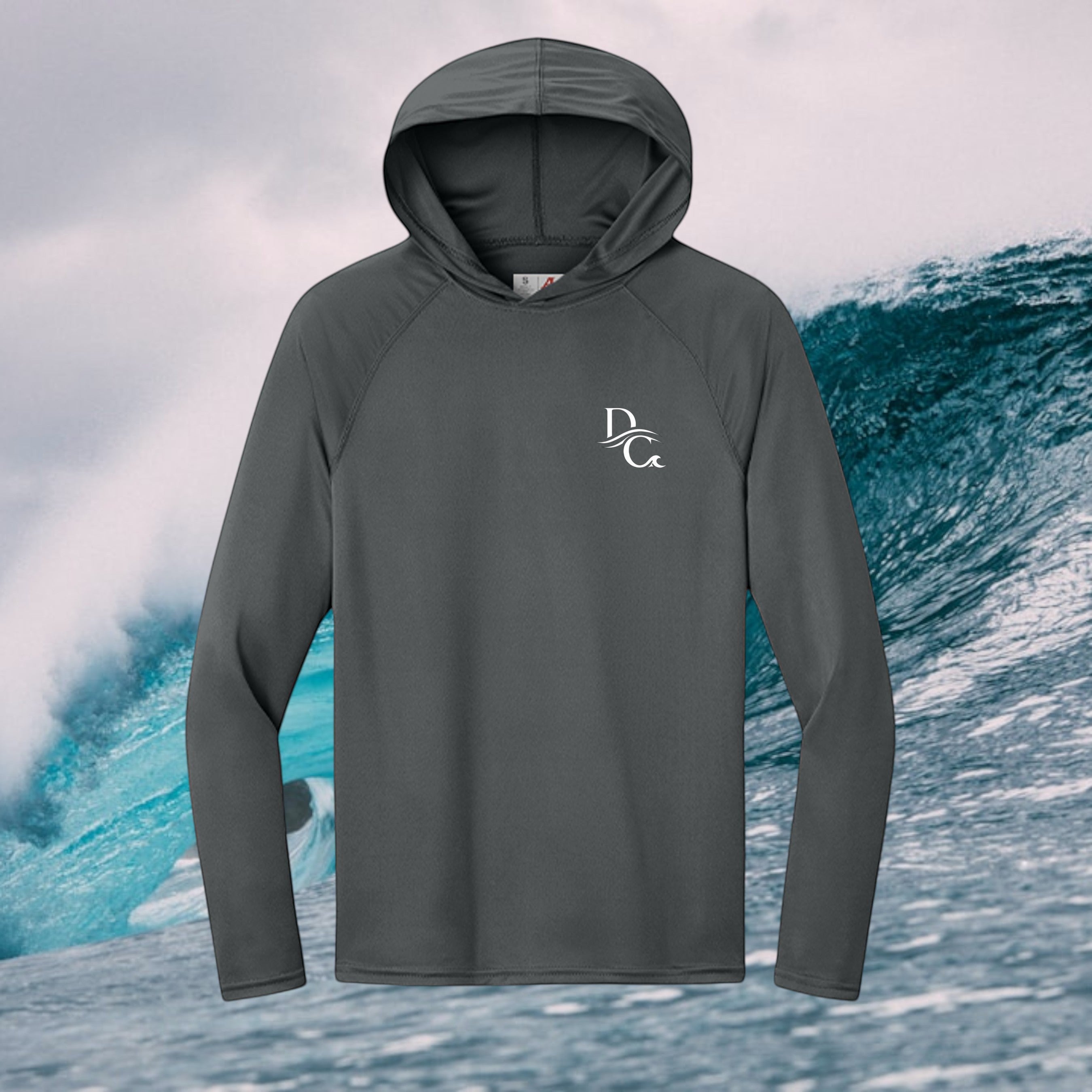 Deepwater Crew Co. dark grey performance UV hoodie with raglan sleeves and white logo against an ocean wave background.