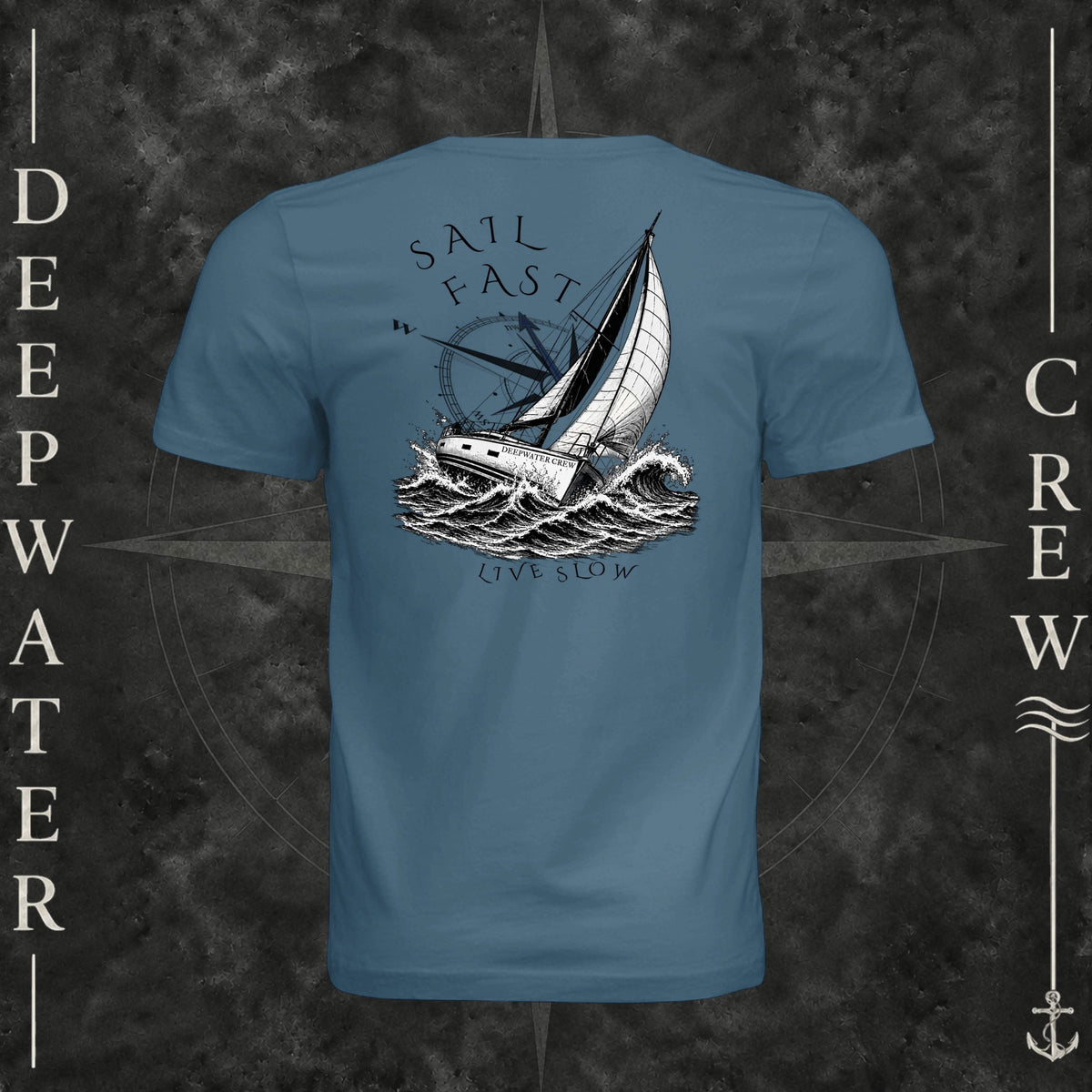 Steel Blue Deepwater Crew Co. Fast & Free crewneck T-shirt, back view with large sailboat, ocean wave and compass graphic featuring “Sail Fast Live Slow” lettering.