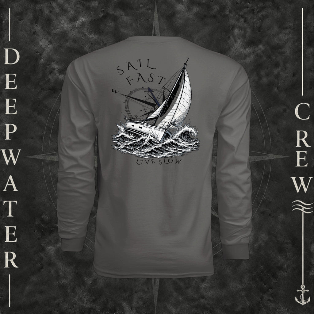 Graphite Deepwater Crew Co. Fast & Free UPF 44+ long-sleeve performance shirt, back view with large sailboat, ocean wave and compass graphic featuring “Sail Fast Live Slow” lettering.