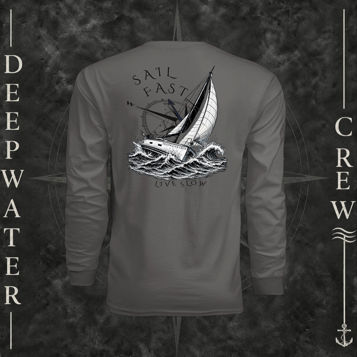 Graphite Deepwater Crew Co. Fast & Free UPF 44+ long-sleeve performance shirt, back view with large sailboat, ocean wave and compass graphic featuring “Sail Fast Live Slow” lettering.