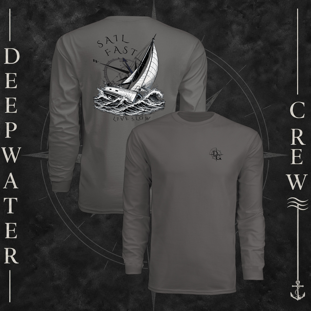 Graphite Deepwater Crew Co. Fast & Free UPF 44+ long-sleeve performance shirt showing front and back views, with small DC compass chest logo and large sailboat, ocean wave, and compass graphic featuring “Sail Fast Live Slow” lettering.