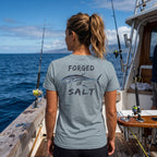 Model wearing a Blue Storm Deepwater Crew Co. Forged of Salt crewneck T-shirt in a lifestyle setting, featuring the stylized tuna graphic.
