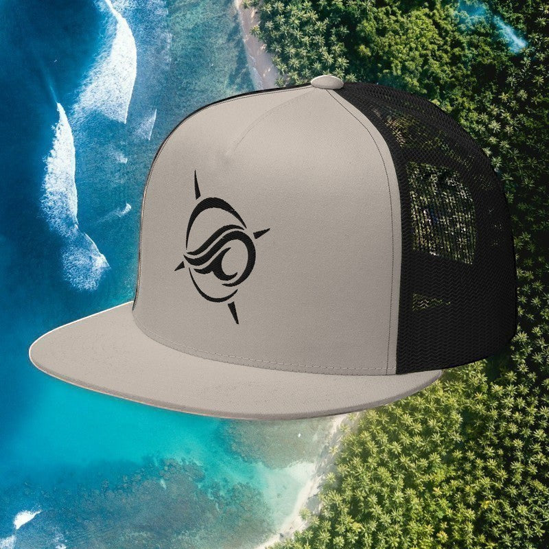 Deepwater Crew Co. grey and black flat bill trucker hat with embroidered wave and compass logo on a coastal background