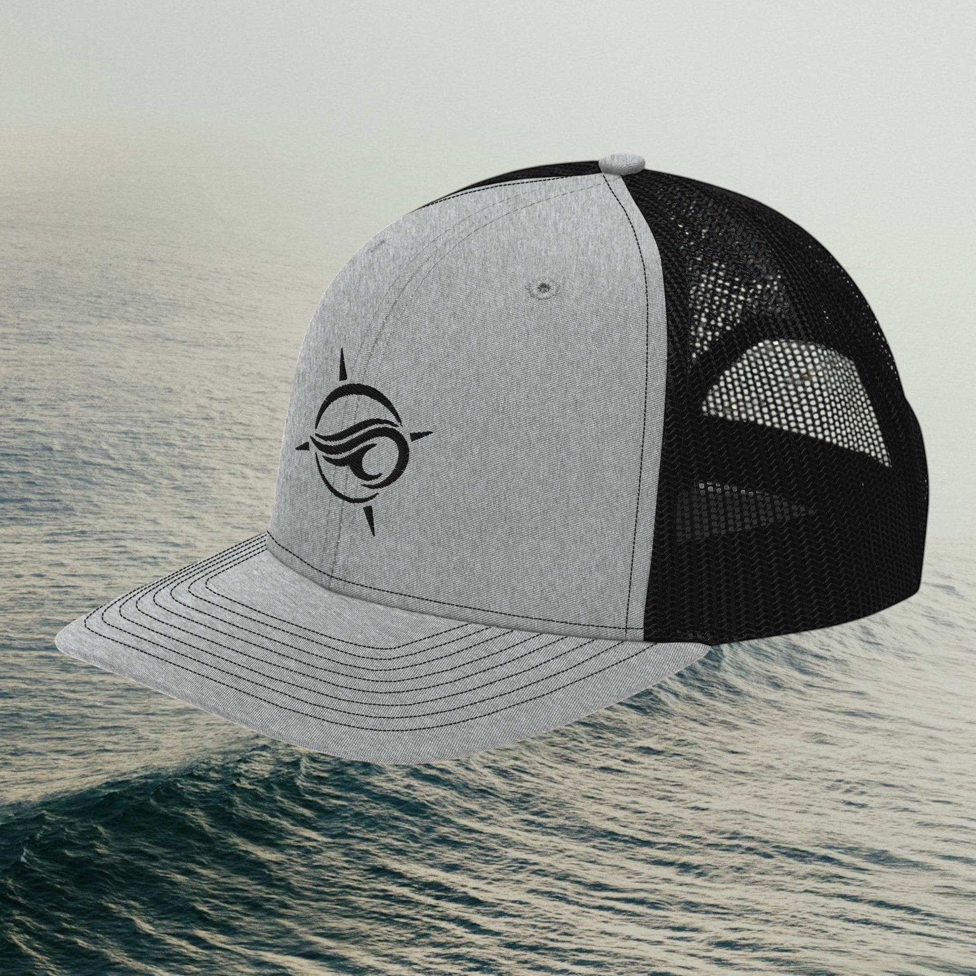 Deepwater Crew Co. grey and black trucker hat with a wave logo embroidery, featuring a mesh back and snapback closure.