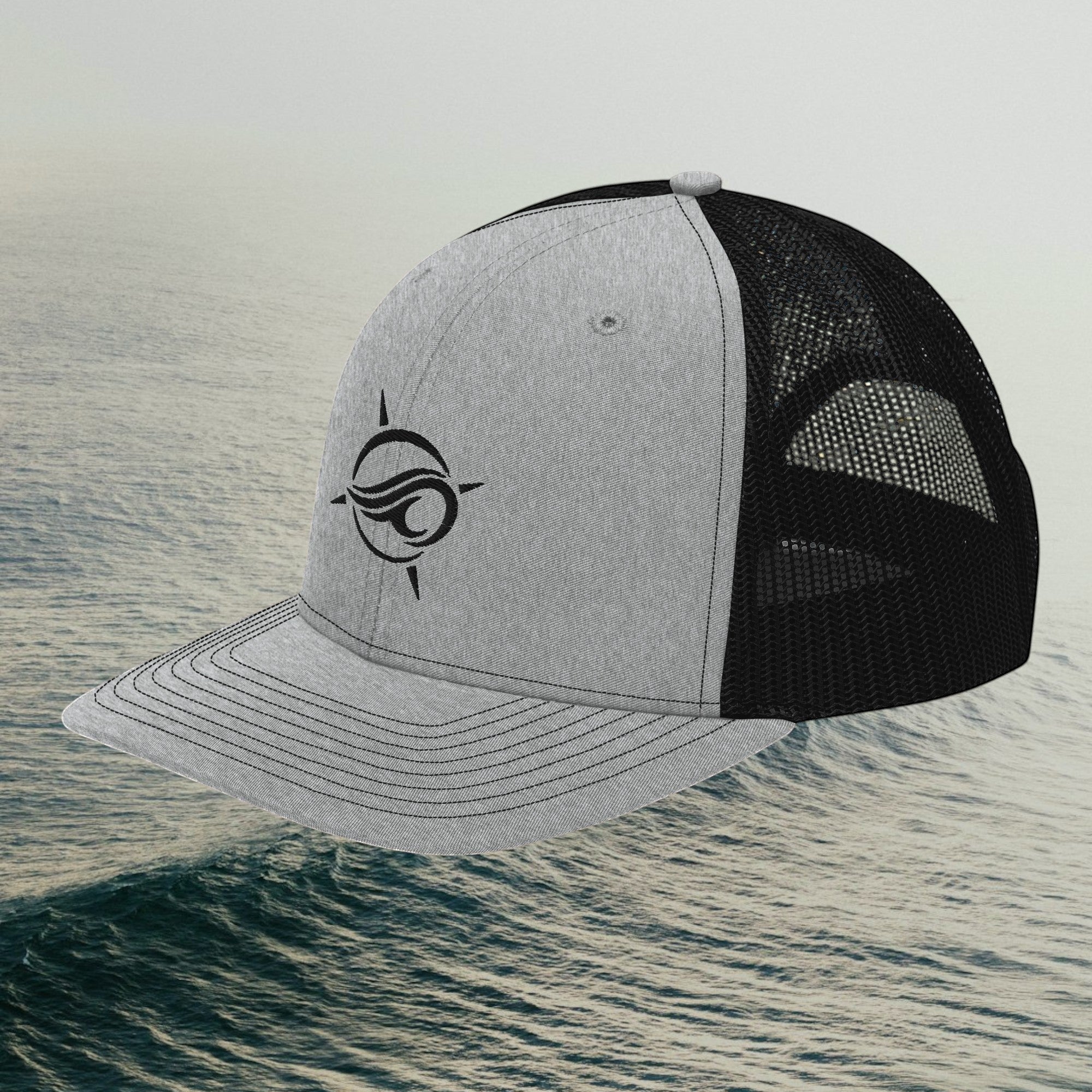 Deepwater Crew Co. grey and black trucker hat with a wave logo embroidery, featuring a mesh back and snapback closure.
