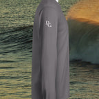 Deepwater Crew Co. grey long sleeve hooded jersey t-shirt with white logo on sleeve against ocean wave background