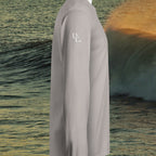 Deepwater Crew Co. light grey long sleeve hooded t-shirt with white logo on sleeve against an ocean wave background.