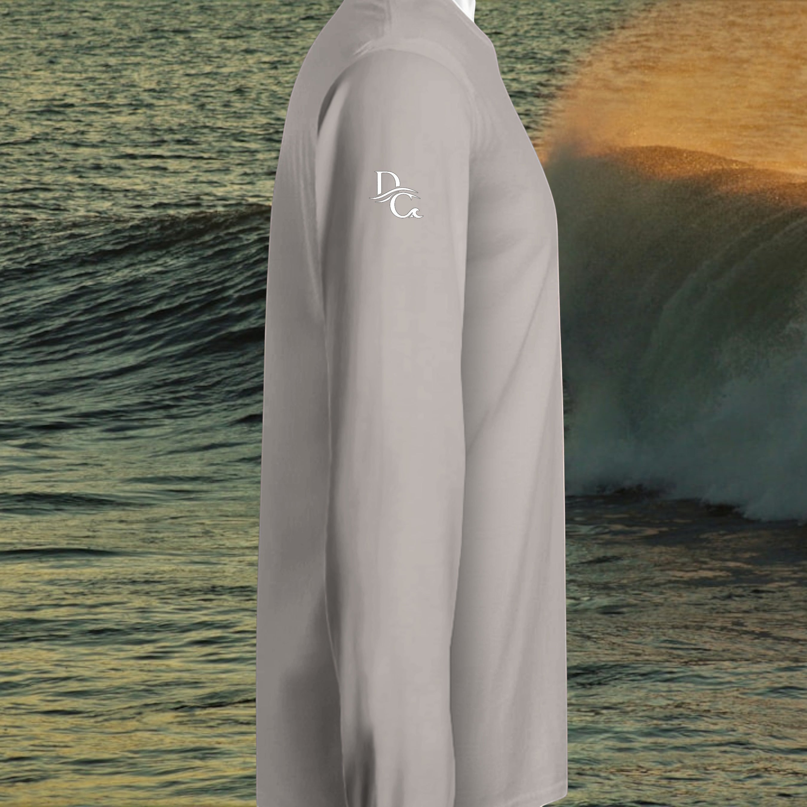 Deepwater Crew Co. light grey long sleeve hooded t-shirt with white logo on sleeve against an ocean wave background.