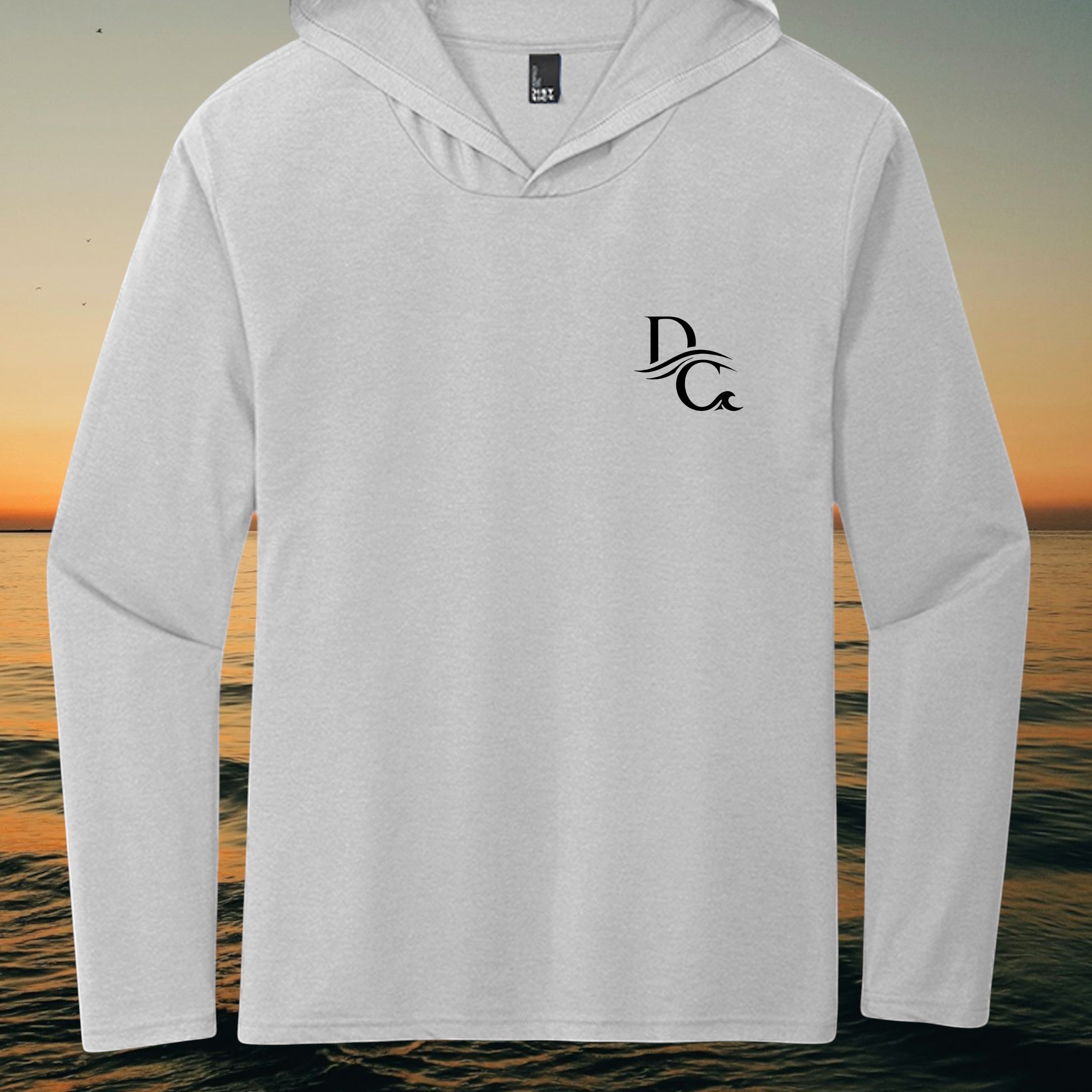 Deepwater Crew Co. light grey tri-blend long sleeve hoodie with a black logo on the chest against a sunset background.
