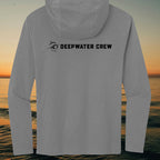 Deepwater Crew Co. grey long sleeve tri-blend hoodie with black logo on back against a sunset ocean background.