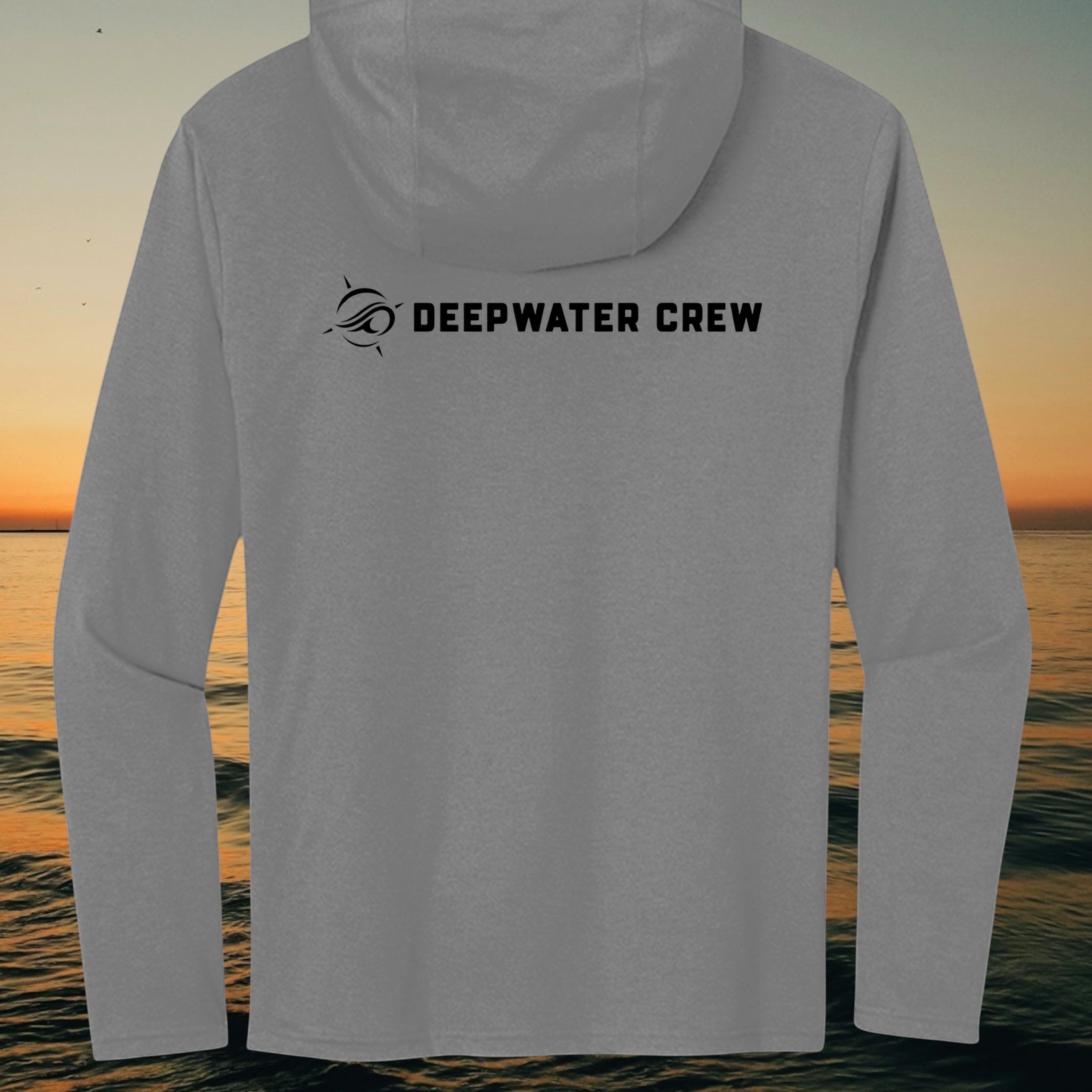 Deepwater Crew Co. grey long sleeve tri-blend hoodie with black logo on back against a sunset ocean background.