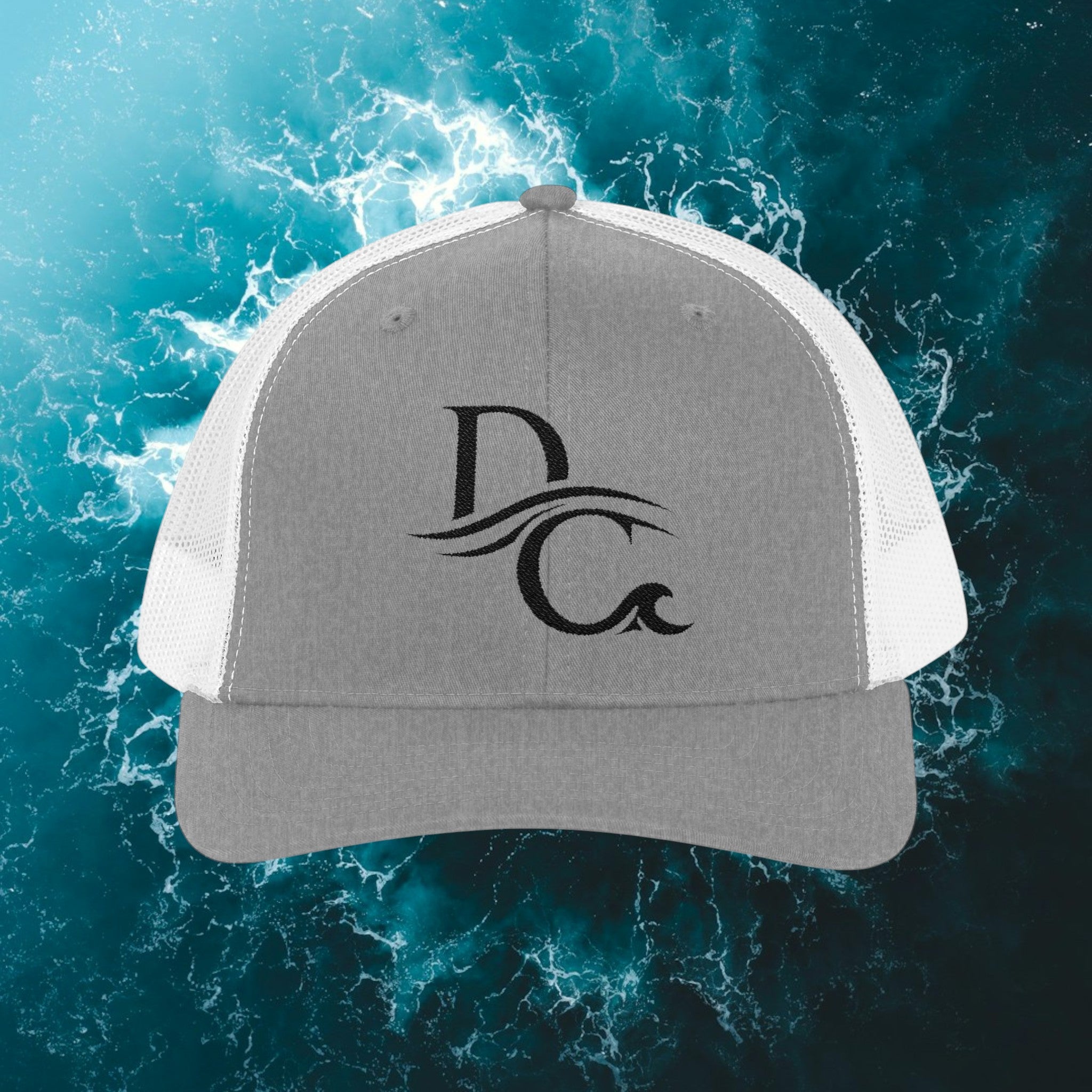 Deepwater Crew Co. grey cotton-polyester blend trucker hat with white mesh back and embroidered DC wave logo.