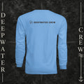Deepwater Crew Co. light blue long-sleeve performance sun shirt with logo on back, shown on a boat deck.