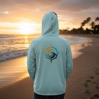 Deepwater Crew Co. light blue performance UPF hoodie with a compass wave logo on the back, worn by a man at sunset.