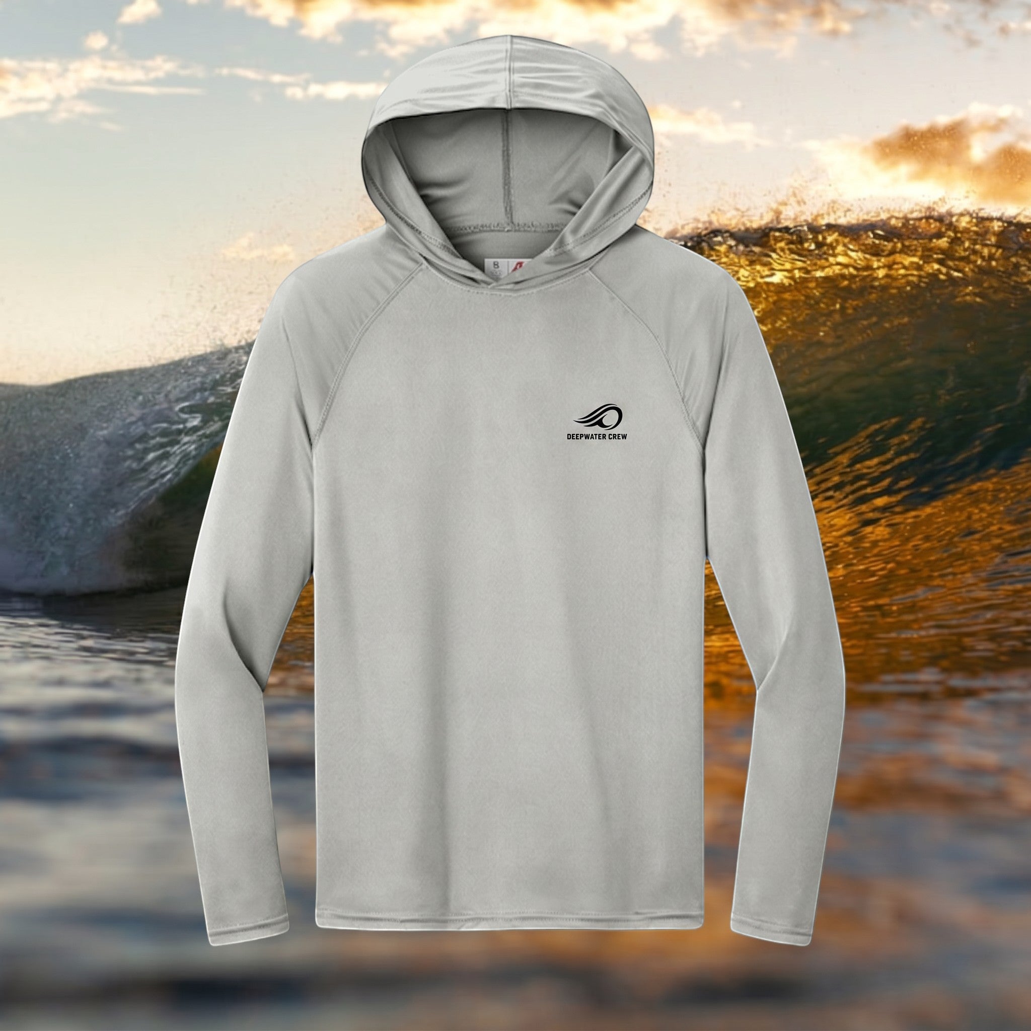 Deepwater Crew Co. light grey performance UPF hoodie with raglan sleeves and logo on chest against an ocean wave.