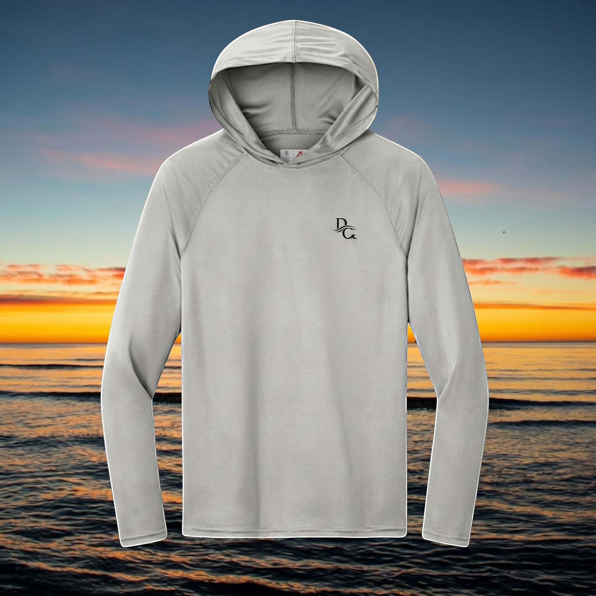 Deepwater Crew Co. light grey performance UPF hoodie with raglan sleeves and logo, set against a sunset ocean backdrop
