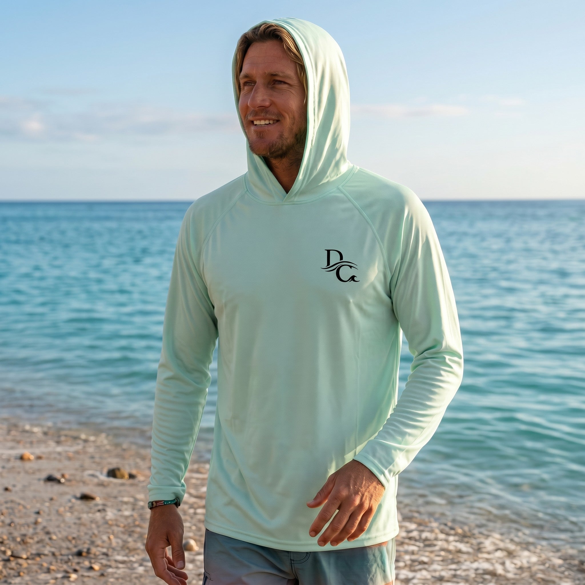 Deepwater Crew Co. men's light green long-sleeve performance UV hoodie with logo on beach