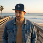 Deepwater Crew Co. navy and white trucker cap with embroidered wave and compass logo, flat bill, mesh back.