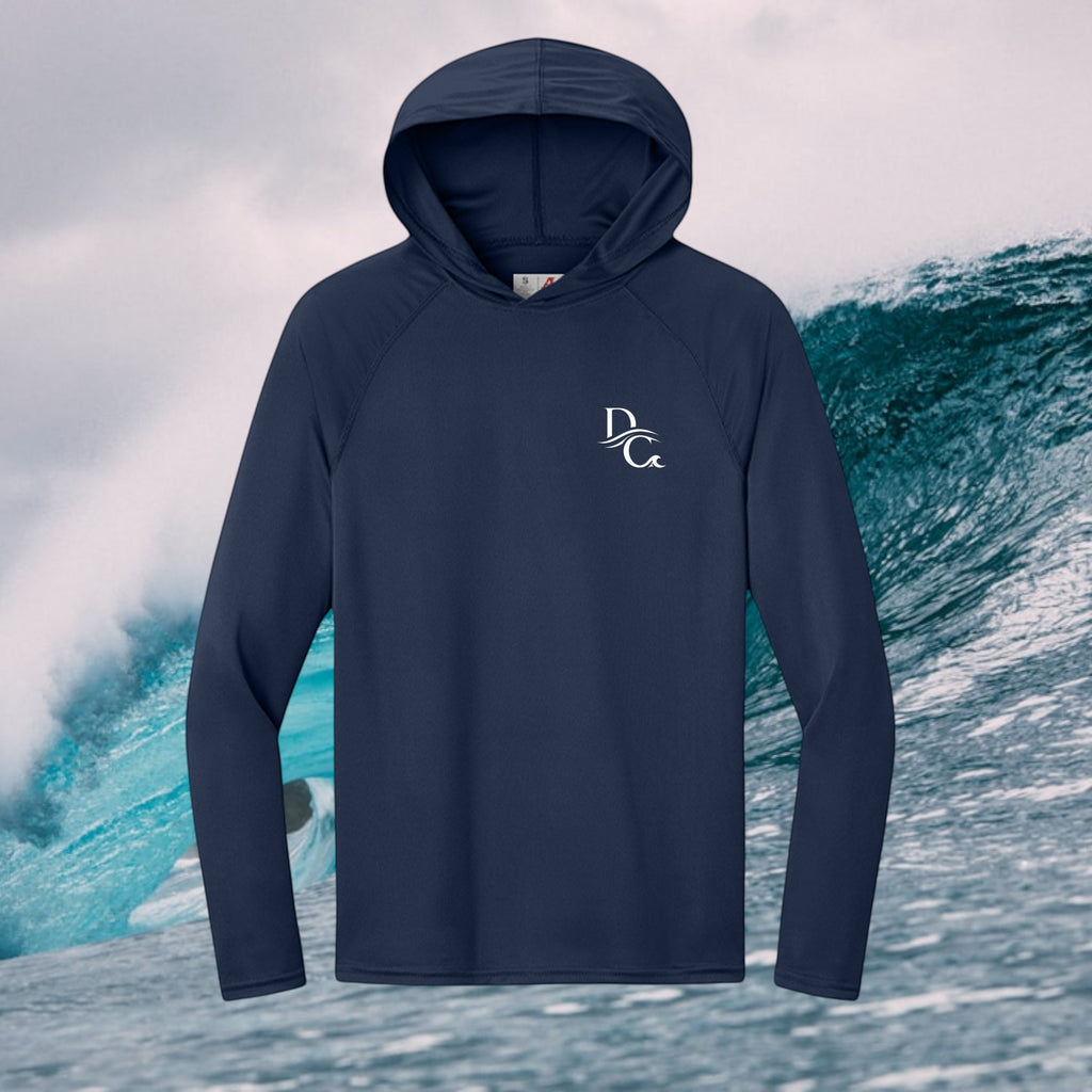 Deepwater Crew Co. dark navy long-sleeve performance UV hoodie with white logo against an ocean wave background.